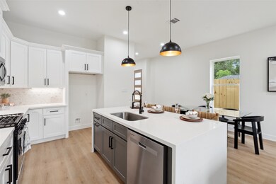 An accent island with a farmhouse-style sink, perfectly positioned to overlook the living area, adding charm and functionality to the heart of the home.