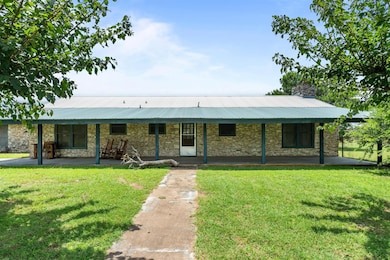 View of front of home featuring a front yard, sto