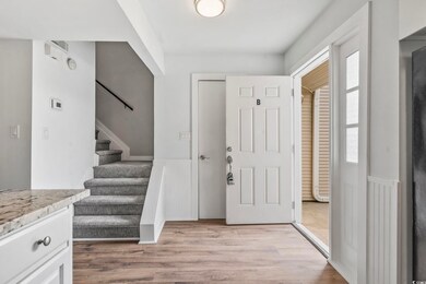 Entrance foyer featuring laminate flooring and stairs