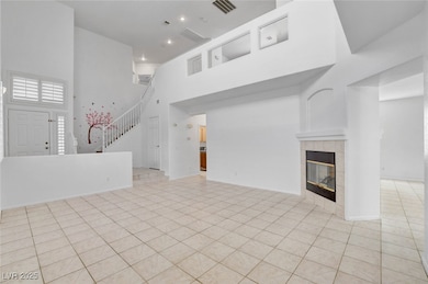 Unfurnished living room featuring light tile patte