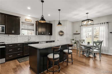 Kitchen featuring hanging light fixtures, light st