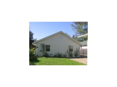 back view of house, yard is fenced with room for a