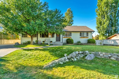 View of front of home featuring a shingled roof and concrete driveway