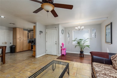 Living area with stone tile floors, a ceiling fan,