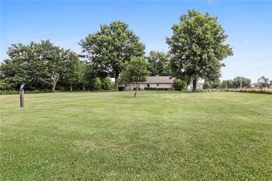 Surrounded by 5 acres of beautiful ground -- level