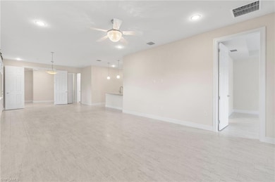 Unfurnished living room with baseboards, visible v
