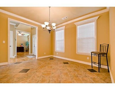 Dining Room. Tiled dining room with crown and tall ceiling