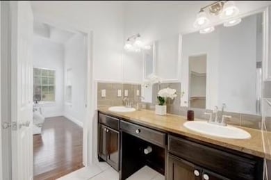 Bathroom featuring double vanity and a sink