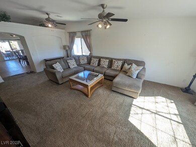 Living room featuring a ceiling fan, visible vents