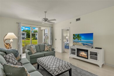Living room with ceiling fan and light hardwood /