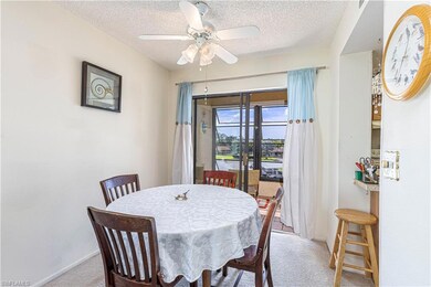 Dining room with ceiling fan, carpet, and a textur