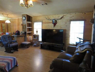 Living area of the 18x76 home with tongue and grove Pine paneling thru out the home with several built ins .