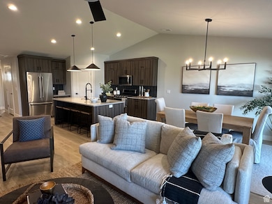 Living room with lofted ceiling, light wood-type flooring, recessed lighting, and a chandelier