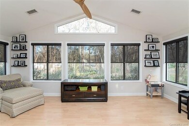 Gorgeous sunroom over looking backyard with roller