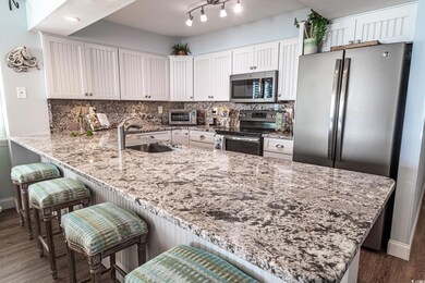 Kitchen with white cabinets, sink, kitchen peninsu
