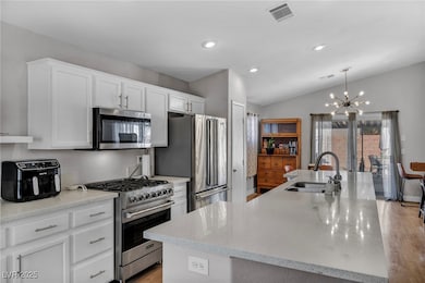 Kitchen featuring visible vents, white cabinets, a