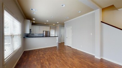 Unfurnished living room featuring ornamental moldi