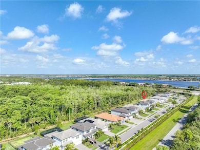 Birds eye view of property with a water view, a wo