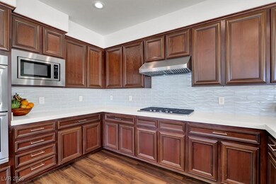 Kitchen with range hood, stainless steel appliance