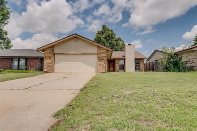 Ranch-style home with brick siding, an attached garage, concrete driveway, and a chimney