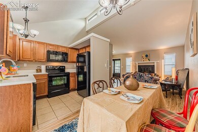 Kitchen featuring black appliances, large deep sin