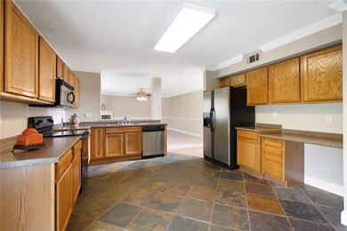 Bright and light kitchen with slate tiled flooring