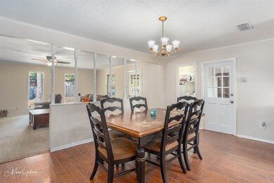 Dining space with crown molding, a textured ceilin