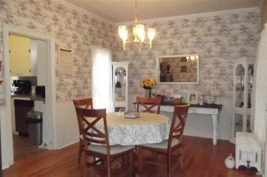 Formal dining room has hardwood floors.