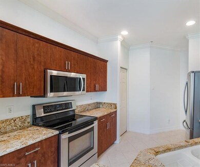 Kitchen featuring crown molding, stainless steel a