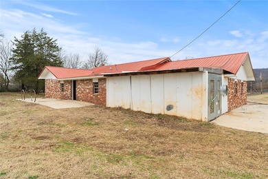 View of outdoor structure featuring a lawn
