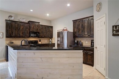 Lots of cabinets and granite countertops plus walk