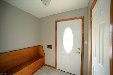 FOYER WITH BENCH AND CLOSET WITH TILE FLOOR