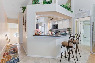 Kitchen with white cabinets, kitchen peninsula, ap