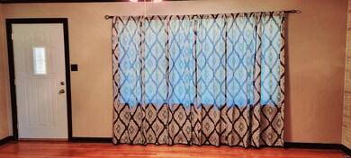 Enter front of full brick house into living room