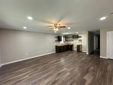 Unfurnished living room with recessed lighting, a ceiling fan, and dark wood-style floors