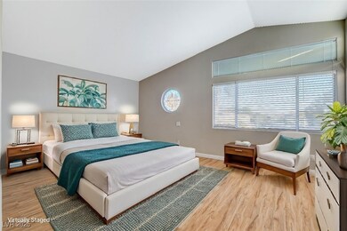 Bedroom with lofted ceiling, light wood-type floor