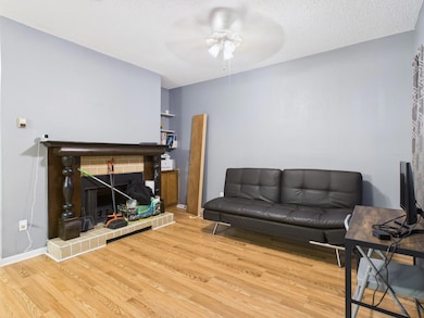 Living area with a ceiling fan, wood finished flo