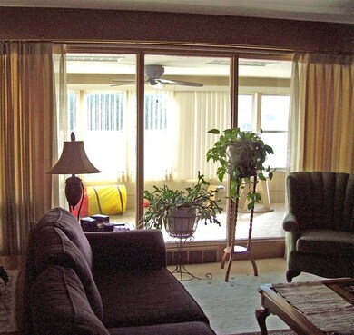 Large picture windows looking into sunroom.