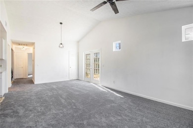 Carpeted spare room featuring visible vents, high 