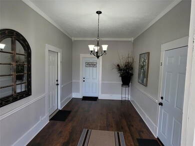 Entryway featuring crown molding, a notable chande