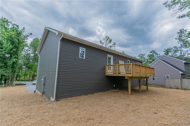 Rear view of property featuring a deck