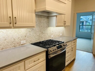 Kitchen with gas stove, custom exhaust hood, backsplash, and light stone countertops