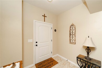 Entrance foyer with light tile patterned floors
