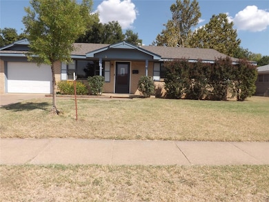 Ranch-style house featuring covered porch, a front lawn, brick siding, an attached garage, and a shingled roof