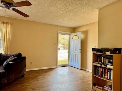 Entrance foyer featuring ceiling fan, wood-type fl