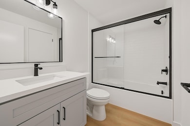 Bathroom featuring wood finished floors, vanity, 