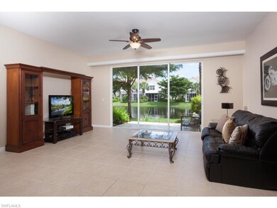 View from the kitchen / dining area of the family room with open air patio and pond view.