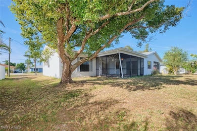 Rear view of property featuring a sunroom and a ya