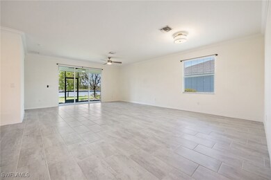 Spare room with crown molding, ceiling fan, and ba