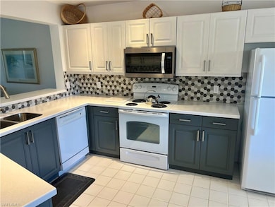Kitchen with a sink, decorative backsplash, white 